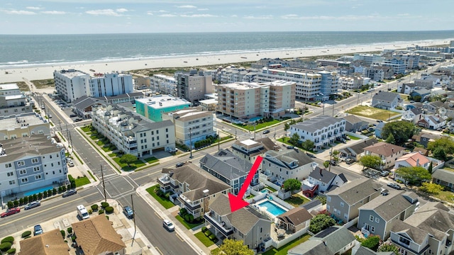 bird's eye view featuring a water view and a beach view