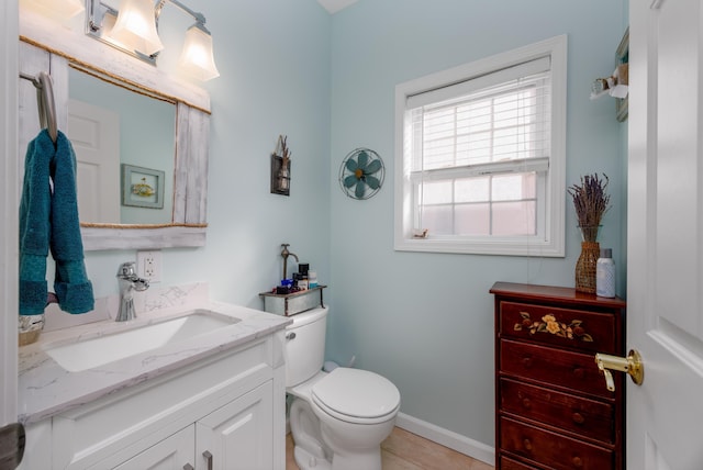 bathroom with tile patterned floors, vanity, and toilet