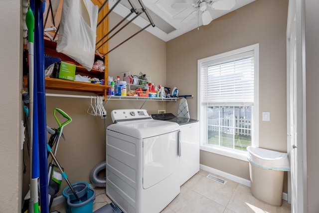 laundry area with ceiling fan, washer and clothes dryer, and light tile patterned flooring