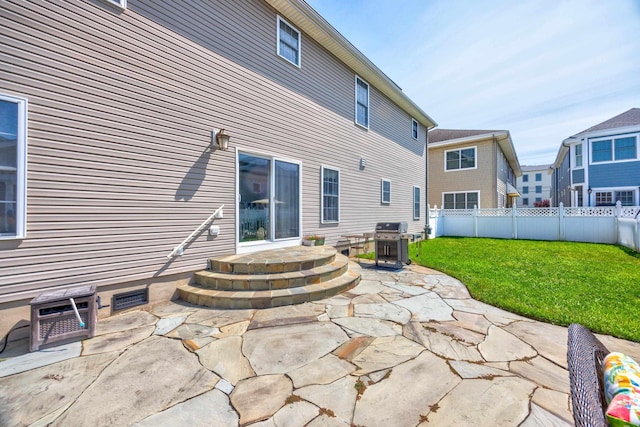 rear view of house featuring a patio and a lawn