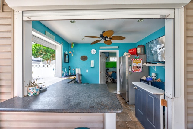 kitchen featuring ceiling fan and stainless steel refrigerator