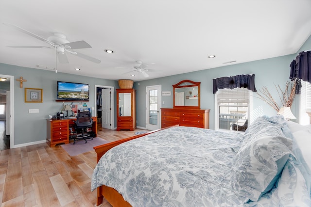 bedroom featuring multiple windows, ceiling fan, and light hardwood / wood-style flooring