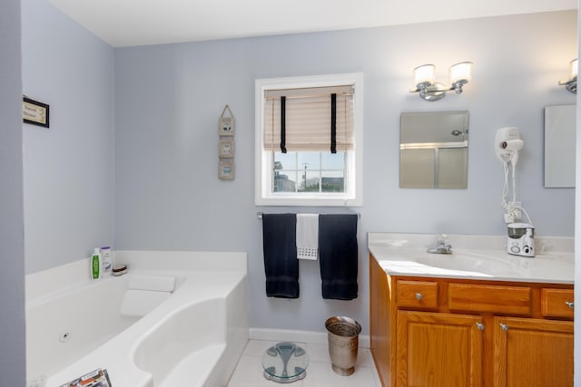 bathroom featuring tile patterned floors, a bathtub, and vanity