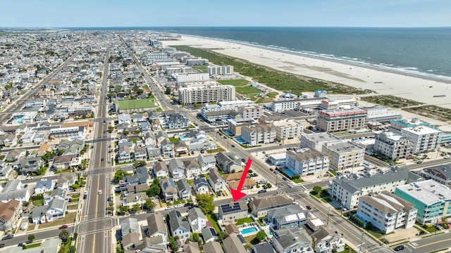 birds eye view of property with a view of the beach and a water view