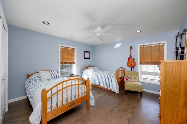 bedroom with ceiling fan, dark hardwood / wood-style flooring, and a closet