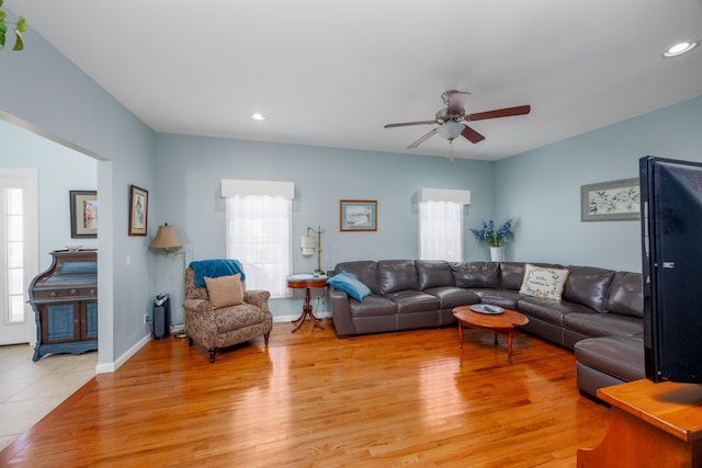 living room featuring ceiling fan and light hardwood / wood-style flooring