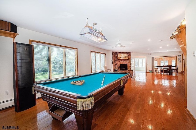 playroom with a fireplace, hardwood / wood-style floors, ceiling fan, and billiards