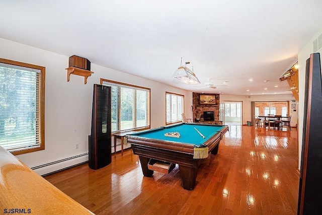 playroom with a fireplace, hardwood / wood-style floors, a baseboard heating unit, and pool table