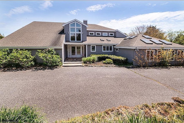 view of front of property featuring solar panels