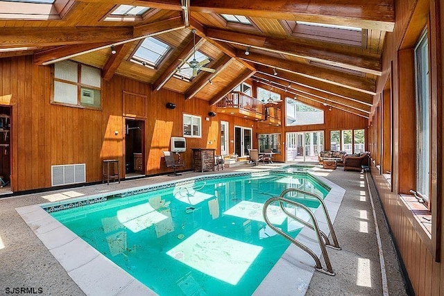 view of swimming pool featuring a skylight