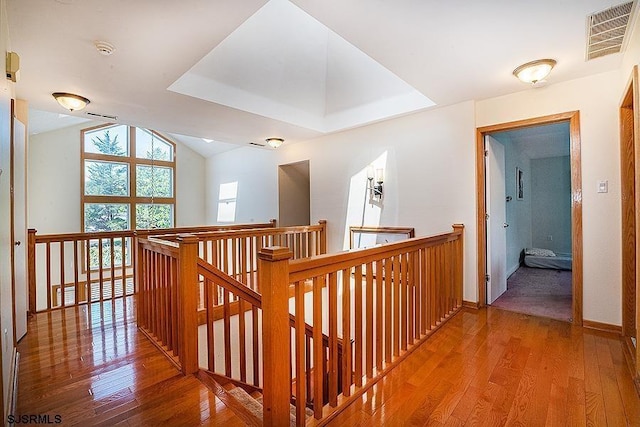 corridor featuring hardwood / wood-style flooring and lofted ceiling