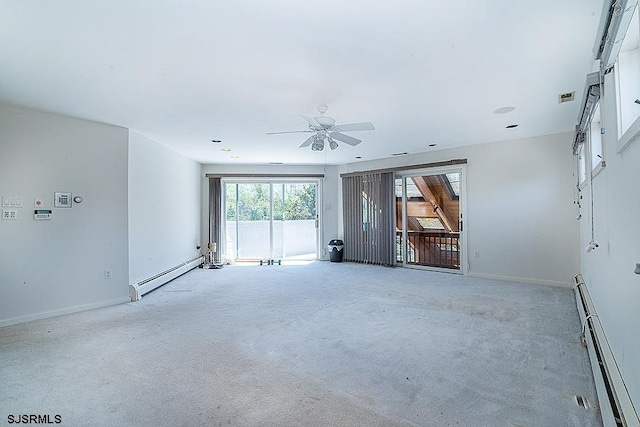 unfurnished room with light carpet, ceiling fan, and a baseboard heating unit