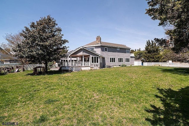 back of house featuring a lawn