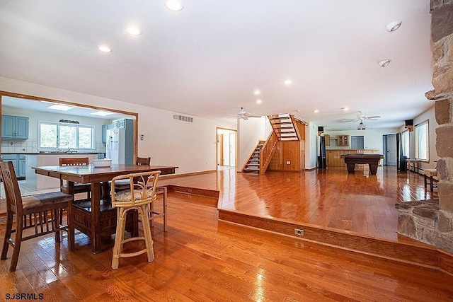 dining space featuring hardwood / wood-style flooring, ceiling fan, and billiards