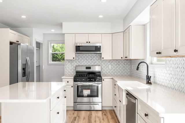 192 Rte 47 S, Cape May Court House, NJ 08210 - kitchen with stainless steel appliances, a sink, light countertops, light wood-type flooring, and backsplash
