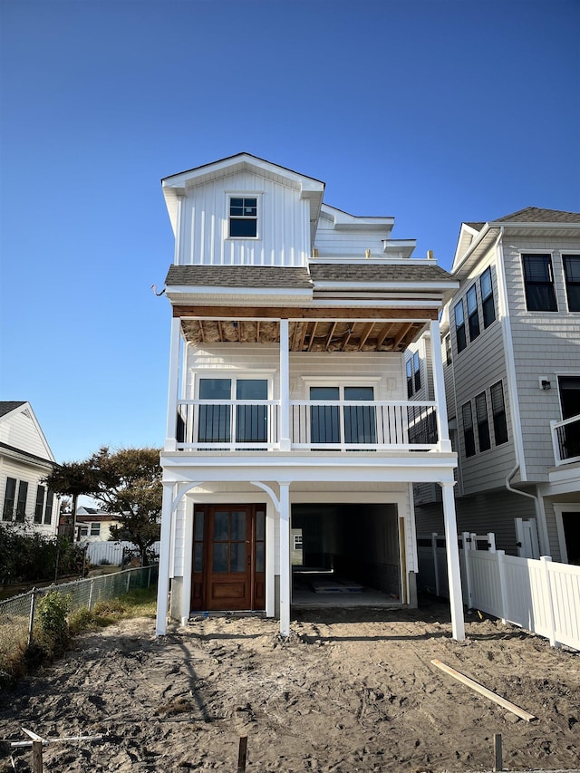 view of front facade featuring a balcony and a carport