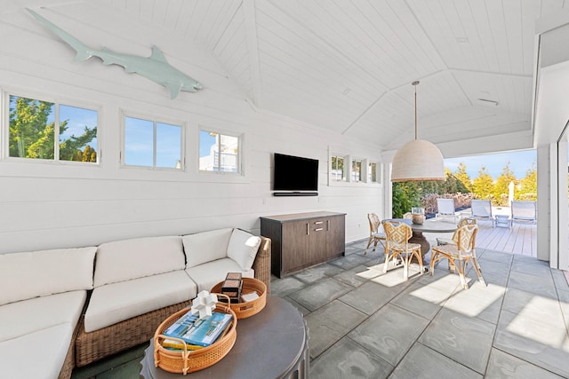 living room featuring wood walls, wooden ceiling, and lofted ceiling