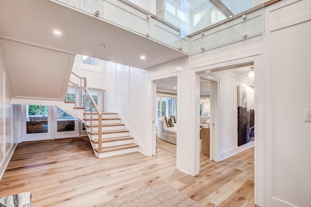 interior space with ornamental molding, light hardwood / wood-style floors, and a healthy amount of sunlight