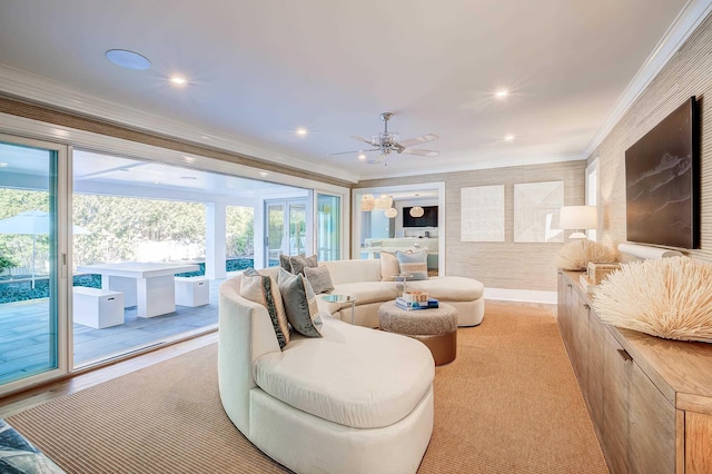 living room with ceiling fan and ornamental molding