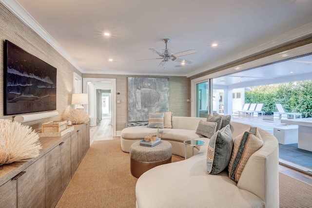 living room with ceiling fan and ornamental molding