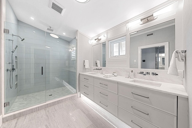 bathroom featuring vanity and a shower with shower door