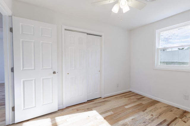 unfurnished bedroom with ceiling fan and light hardwood / wood-style floors