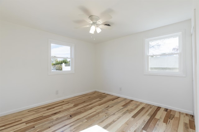 spare room with light hardwood / wood-style floors and ceiling fan