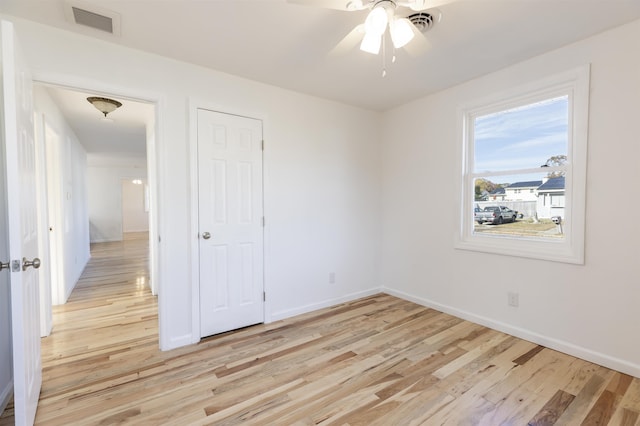 unfurnished bedroom with ceiling fan and light hardwood / wood-style flooring