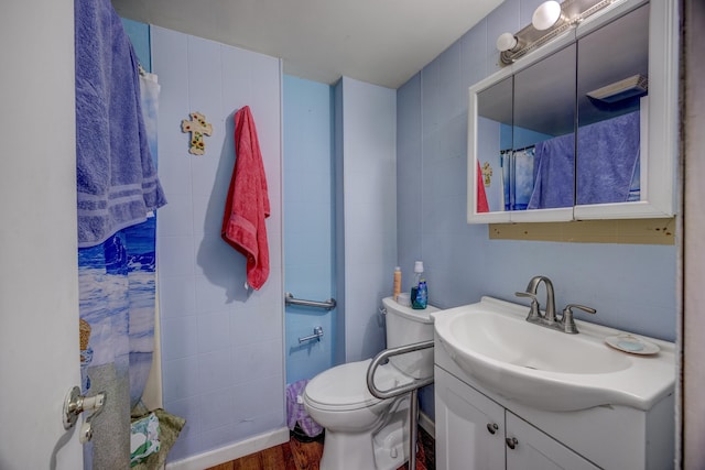 bathroom featuring vanity, hardwood / wood-style floors, and toilet