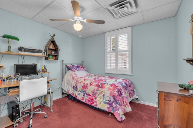 bedroom featuring carpet, ceiling fan, and a drop ceiling