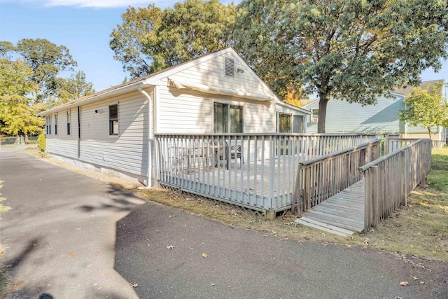 view of property exterior featuring a deck