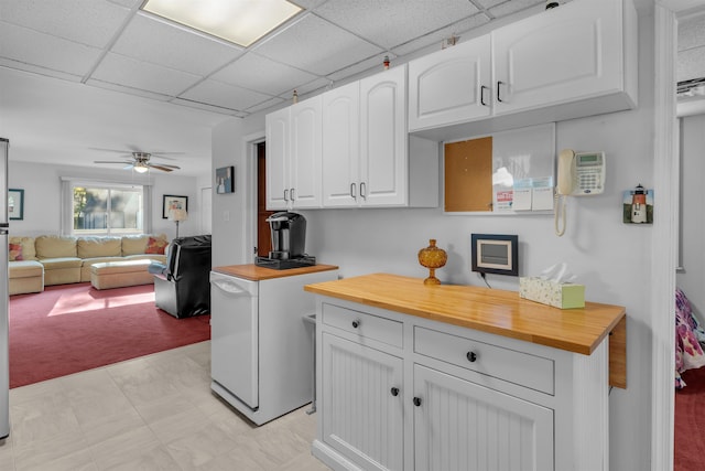 kitchen featuring refrigerator, ceiling fan, white cabinets, and wood counters