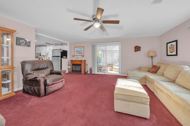 carpeted living room with ceiling fan