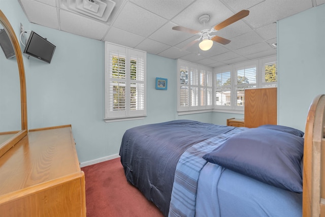 bedroom featuring carpet flooring, a paneled ceiling, and ceiling fan