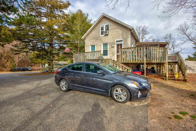 view of front of property featuring stairs and a wooden deck