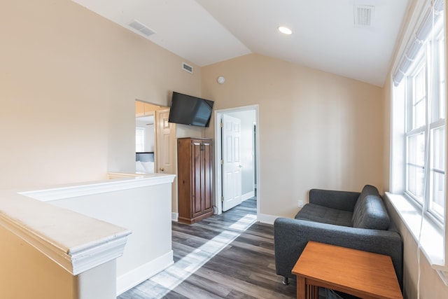 living area with dark hardwood / wood-style floors and vaulted ceiling