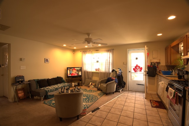 tiled living room featuring ceiling fan and sink