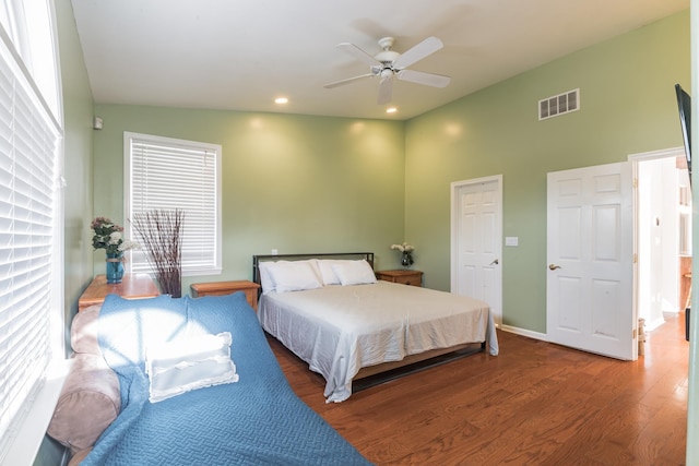 bedroom featuring hardwood / wood-style floors, vaulted ceiling, and ceiling fan