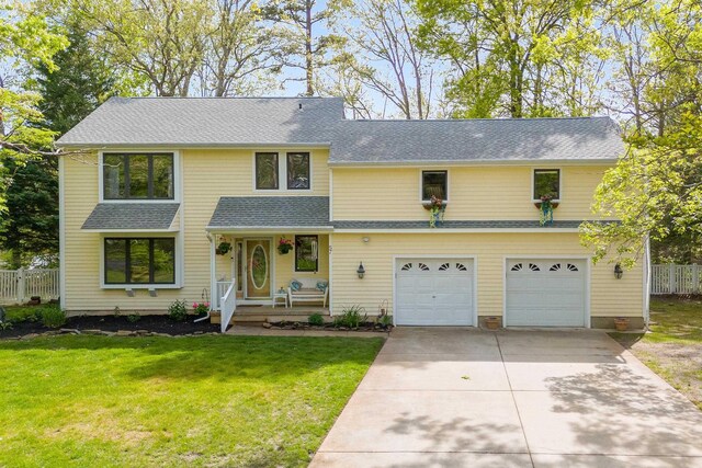 57 Somers Ave, Seaville, NJ 08230 - view of front of home with concrete driveway, an attached garage, roof with shingles, and covered porch