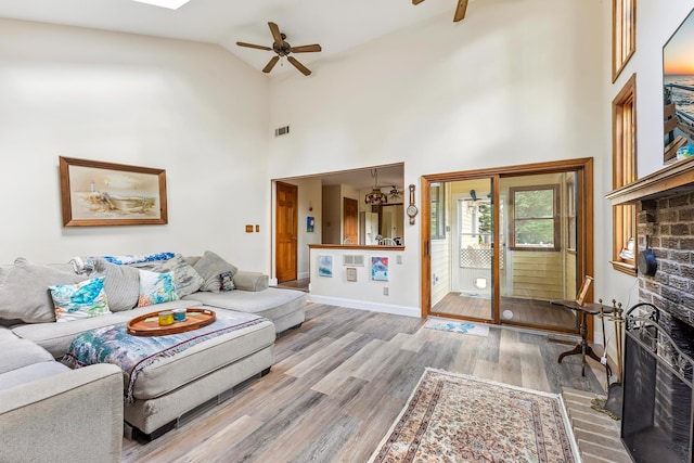 57 Somers Ave, Seaville, NJ 08230 - living room with a ceiling fan, light wood-style flooring, baseboards, high vaulted ceiling, and a fireplace