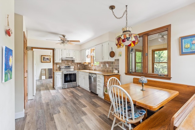 57 Somers Ave, Seaville, NJ 08230 - kitchen with stainless steel appliances, a sink, a ceiling fan, under cabinet range hood, and white cabinetry