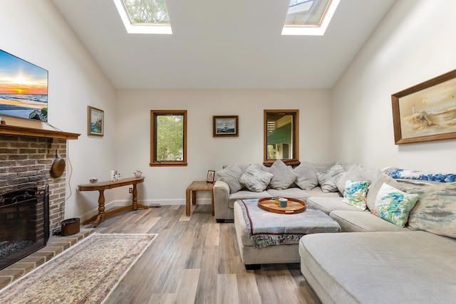 57 Somers Ave, Seaville, NJ 08230 - living room featuring a skylight, vaulted ceiling, a fireplace, light wood-style floors, and baseboards