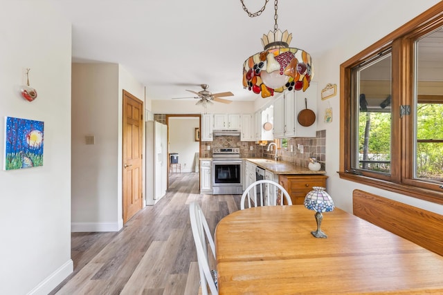 57 Somers Ave, Seaville, NJ 08230 - dining area featuring light wood-style floors, a ceiling fan, and baseboards