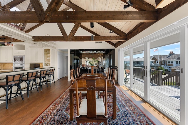 dining space with beam ceiling, dark hardwood / wood-style flooring, wooden ceiling, and high vaulted ceiling