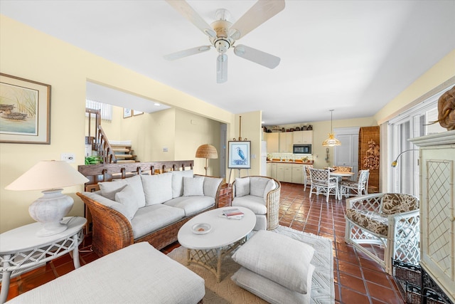 tiled living room featuring ceiling fan and a healthy amount of sunlight