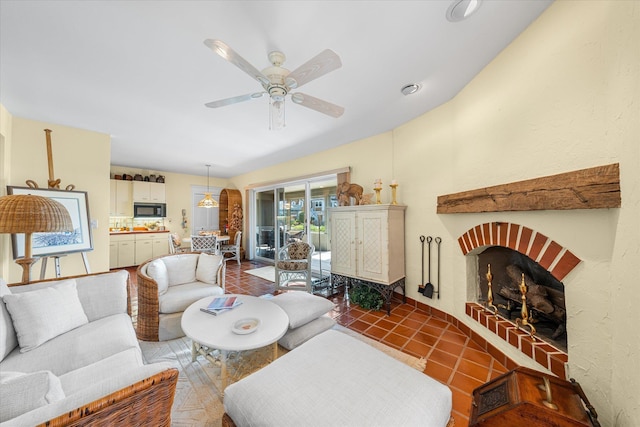 tiled living room with ceiling fan and a brick fireplace