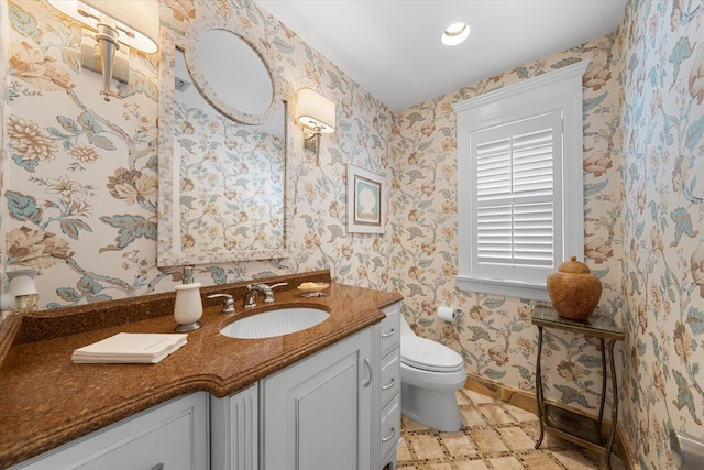 bathroom featuring vanity and toilet