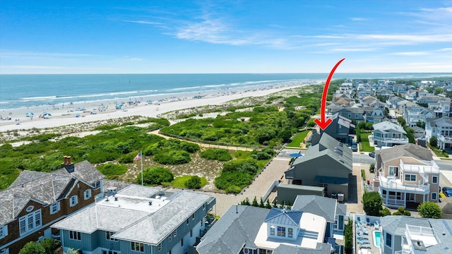 birds eye view of property featuring a view of the beach and a water view