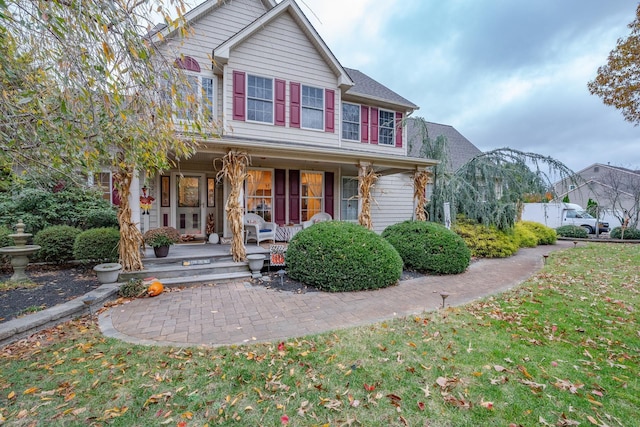 view of front facade featuring a porch and a front yard