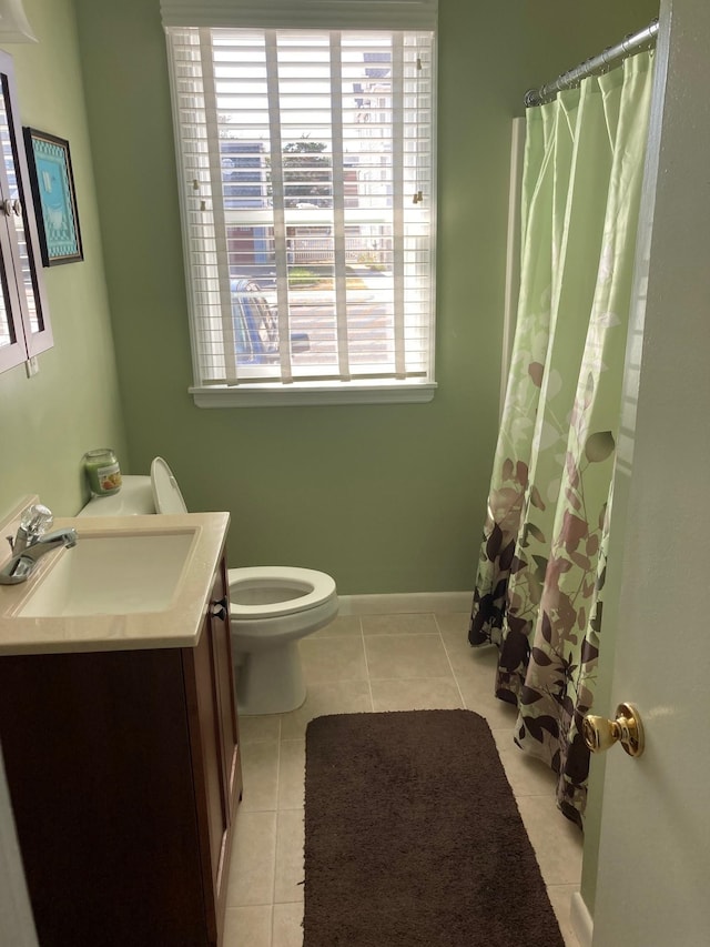 bathroom featuring toilet, vanity, and tile patterned floors